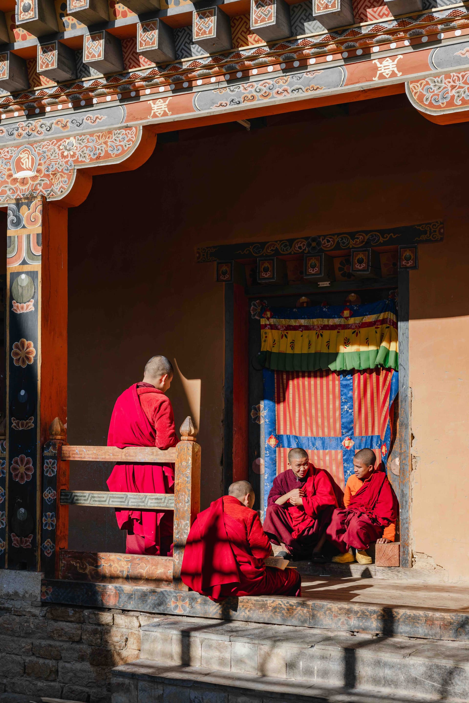 Smiling Buddhist monks in Bhutan representing the joy of the Gross National Happiness philosophy.